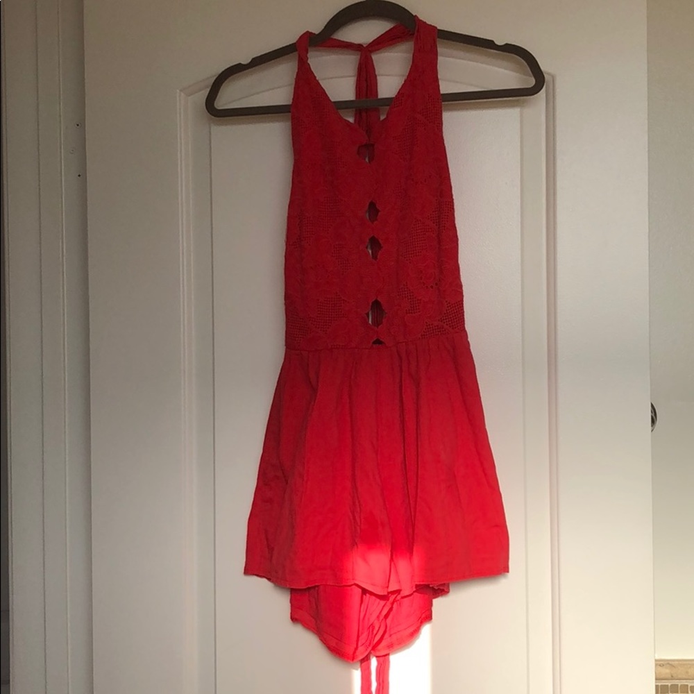 Of red open back halter romper